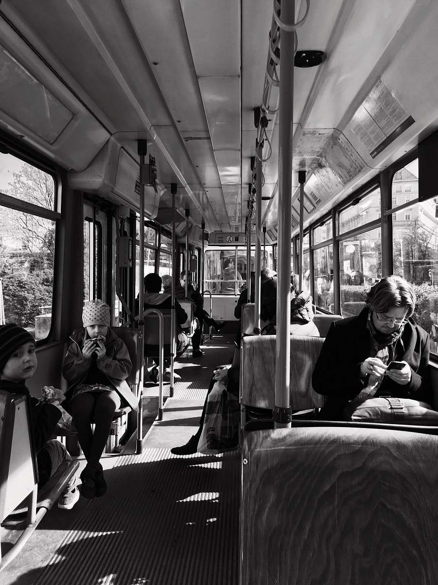 human grayscale photo of person inside bus black-and-white