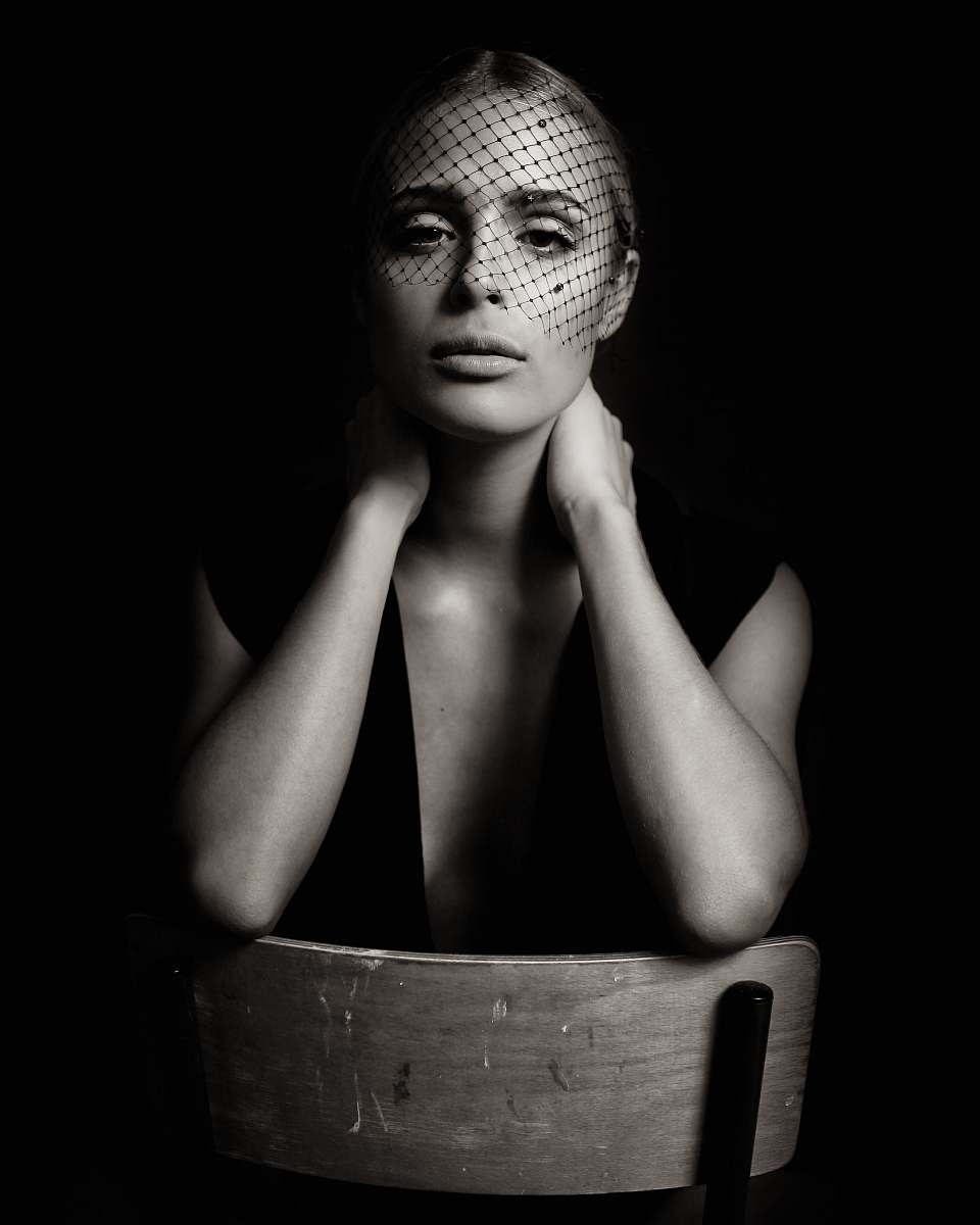 human grayscale photo of woman sitting on chair person