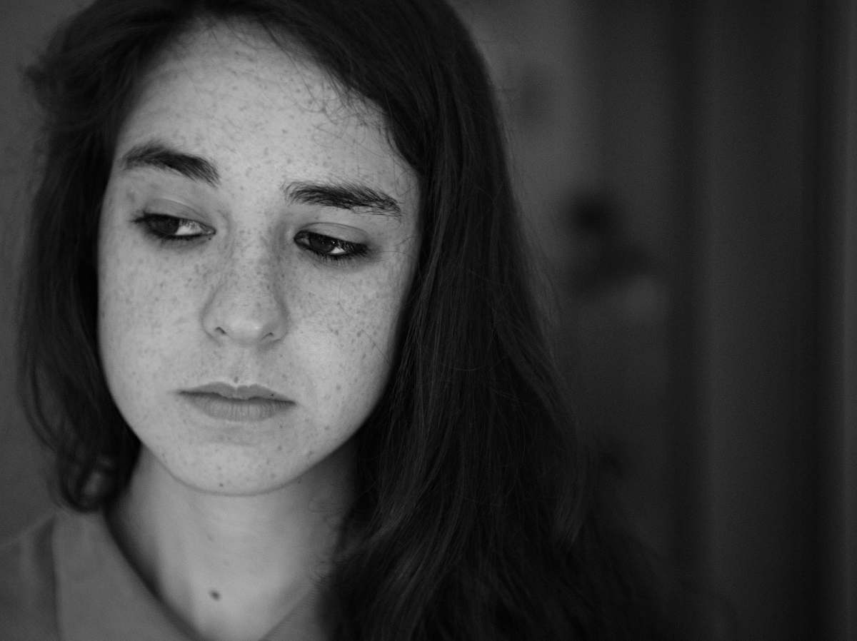 person grayscale photo of woman wearing collared shirt black-and-white