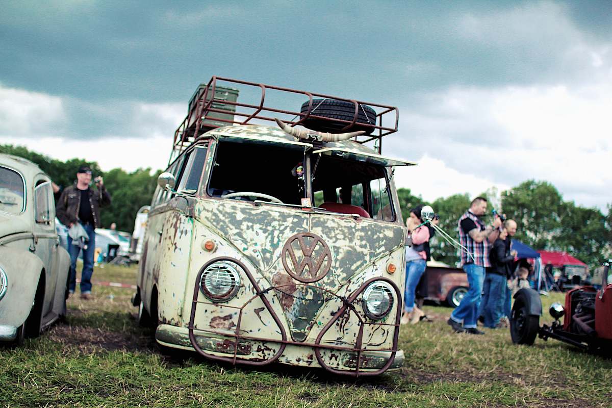 vehicle group of people near Volkswagen T1 on green grass field transportation