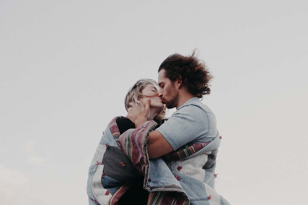 person low angle photograph of man and woman kissing human