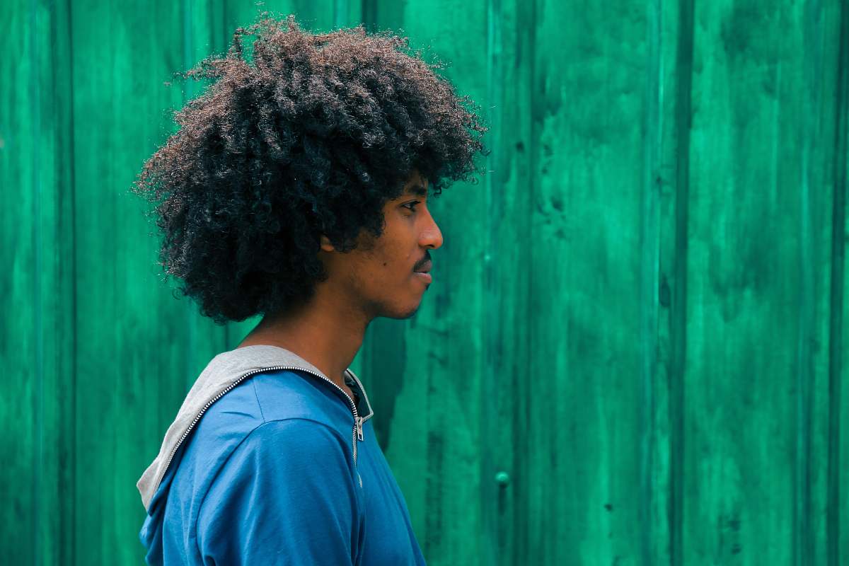 human man facing right near green wall person