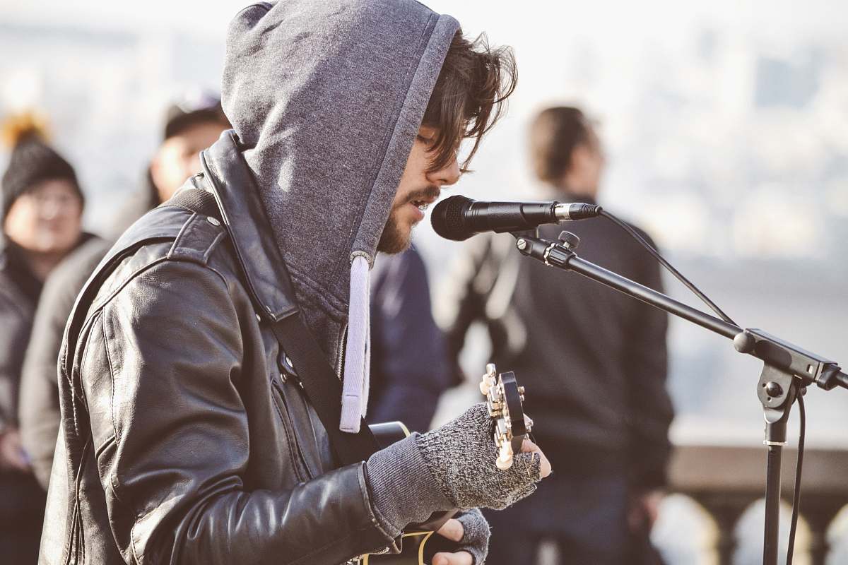 person man facing sideways playing guitar human