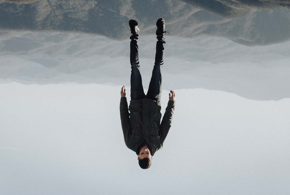 human man floating above mountain person