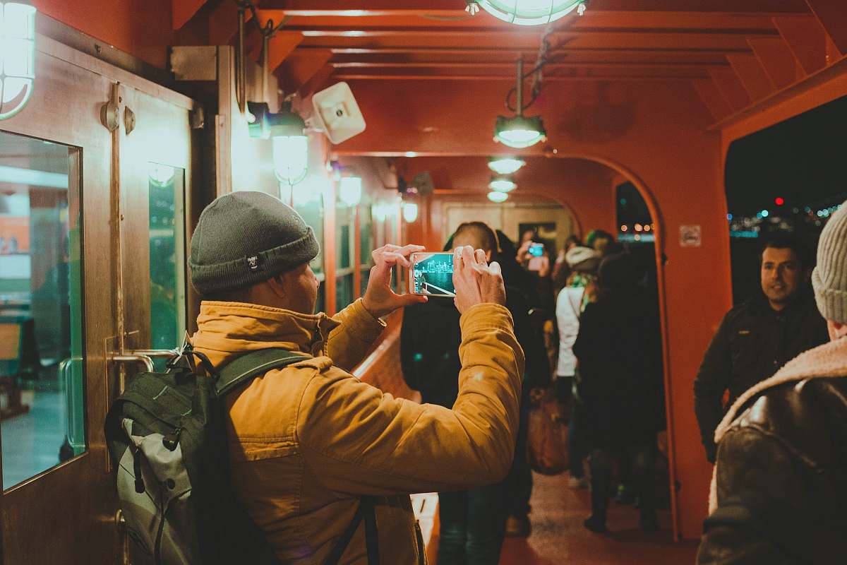 person man in brown jacket holding phone human