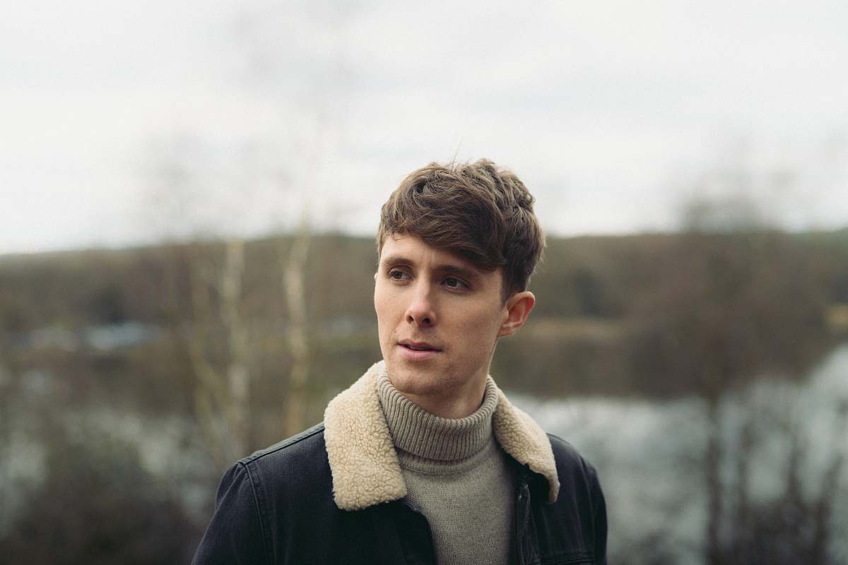 human man in gray turtleneck top standing person