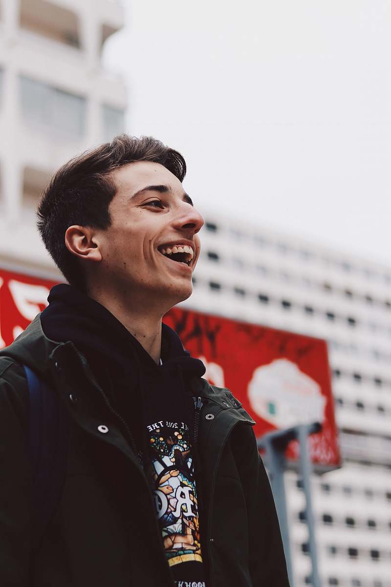 human man laughing near building person
