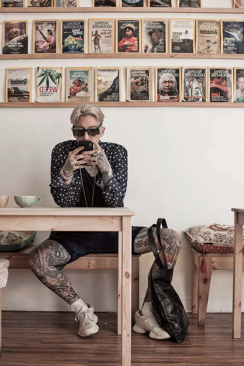 person man sitting on bench near table tattoo