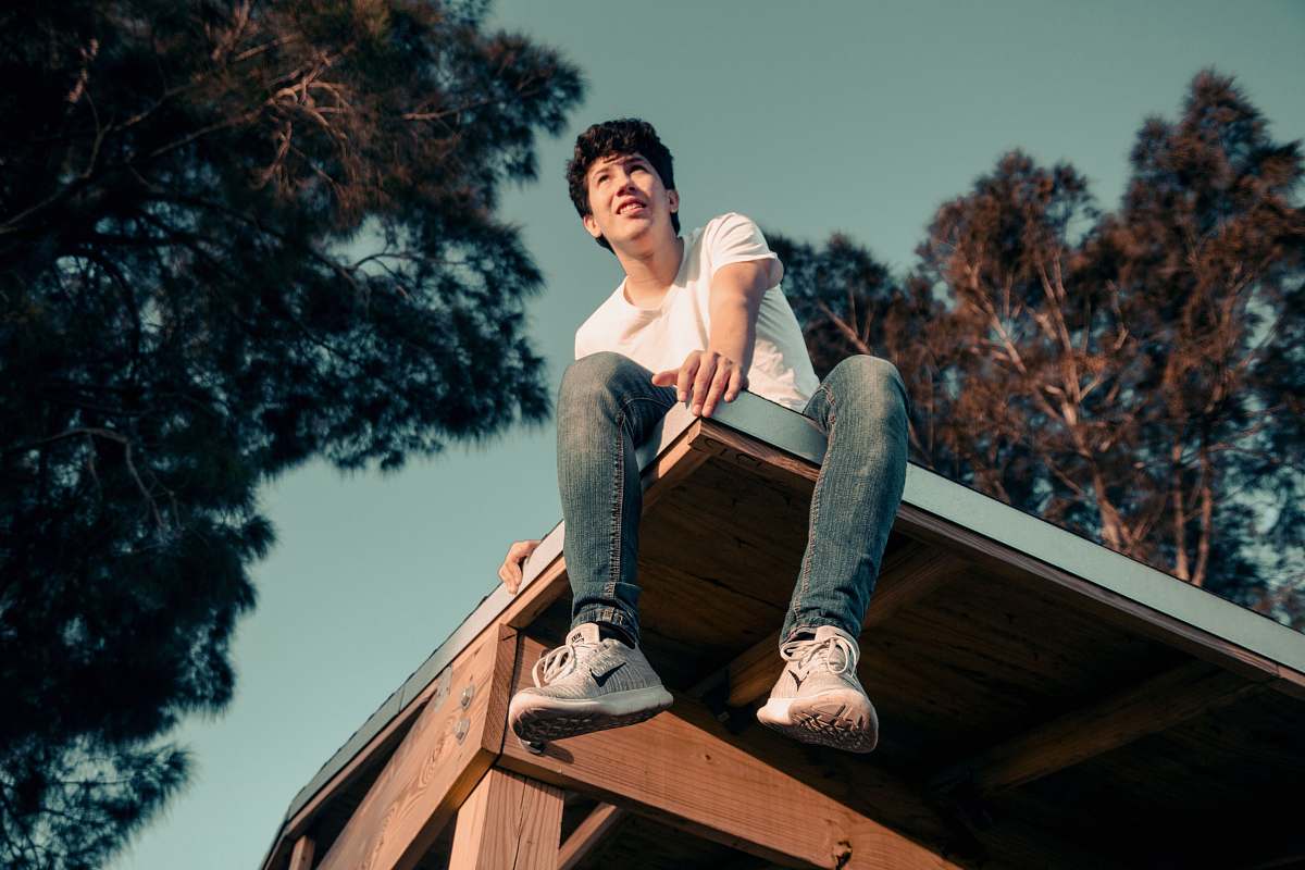 person man sitting on roof human