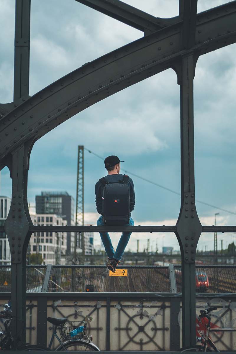 bike man sitting on top of bridge human