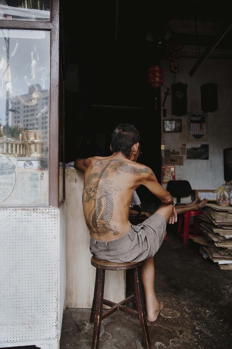 human man sitting on wooden stool person
