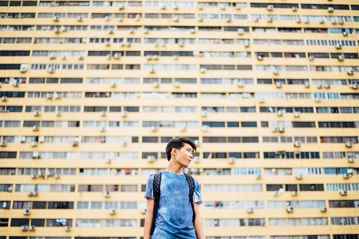 person man standing in front of skyscraper human
