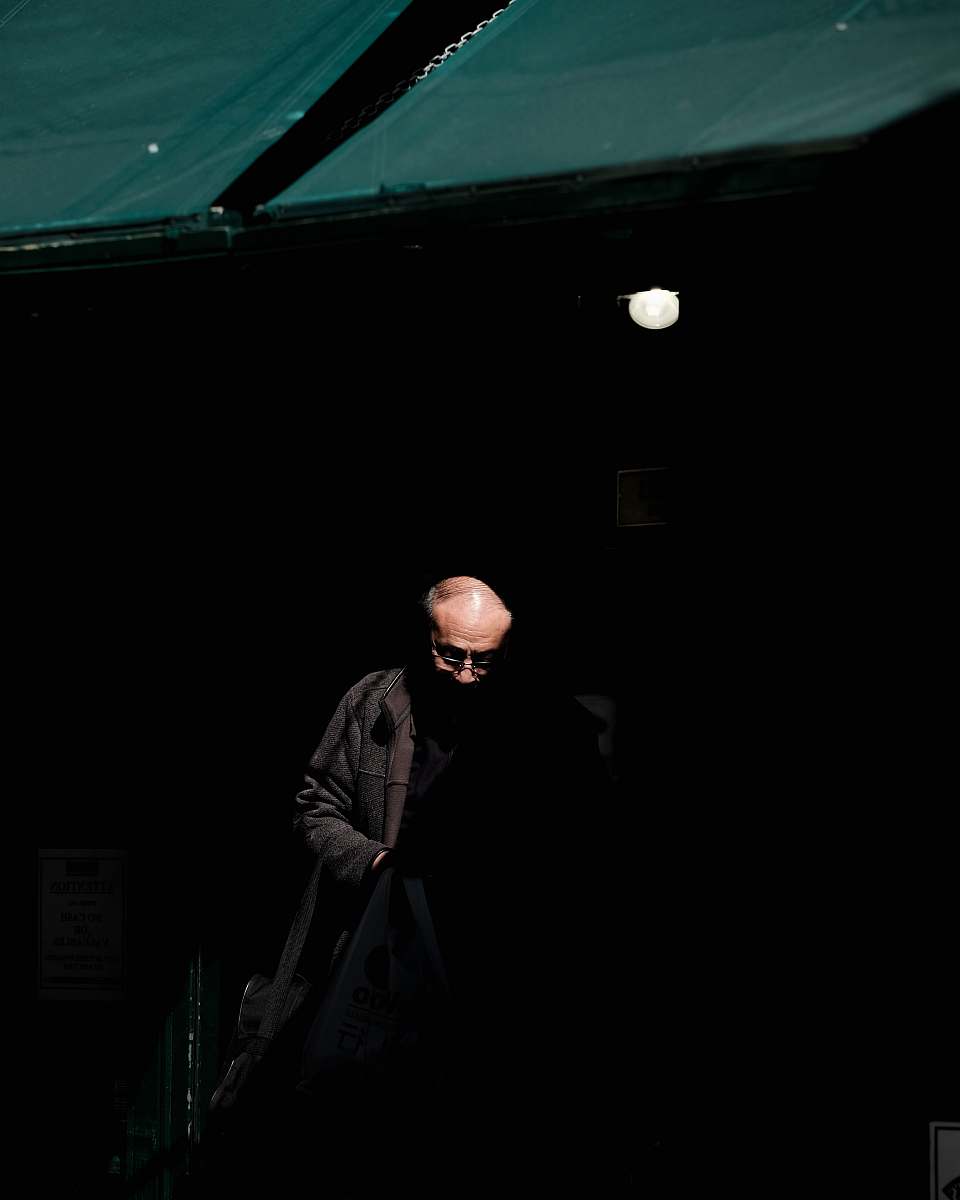 human man wearing black jacket inside dark room person