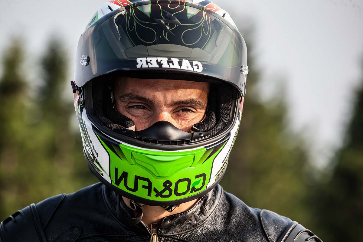 person man wearing black multicolored helmet helmet