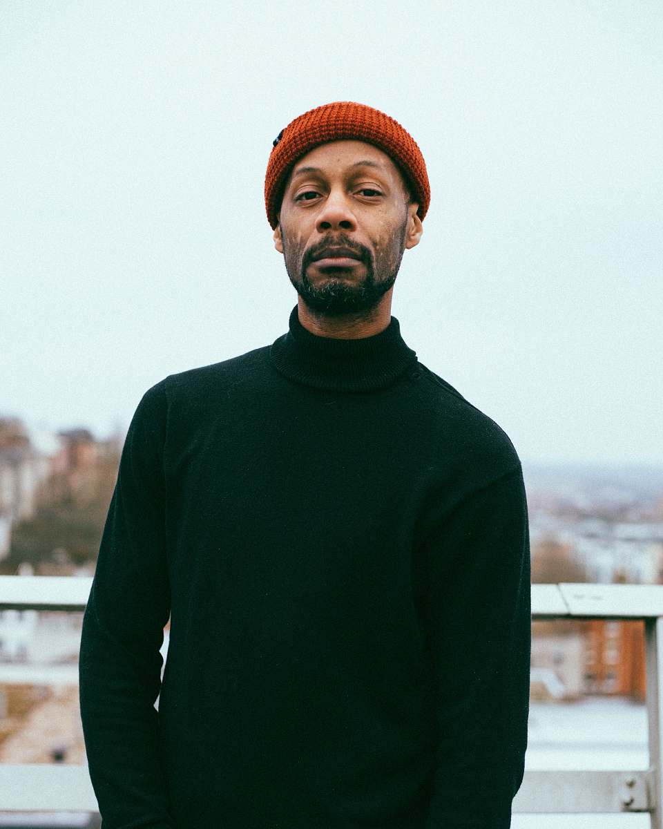 person man wearing black sweater and red knitted cap human