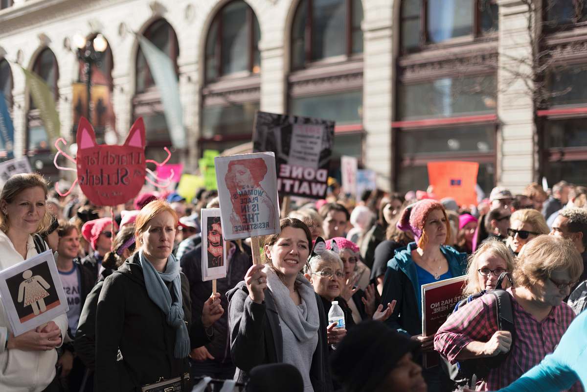 person people holding flyers during daytime crowd