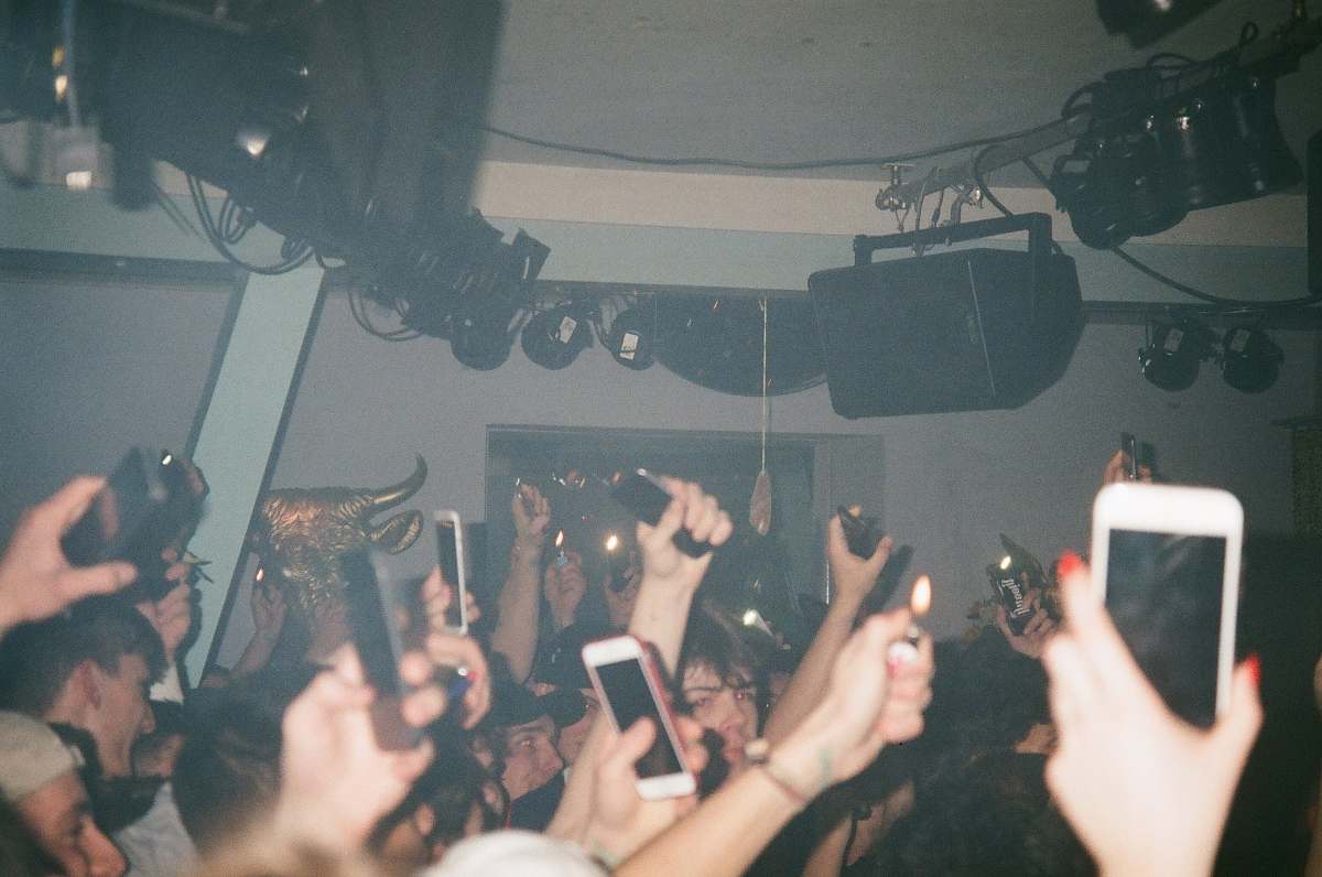 human people raising their hands and holding their smartphones person