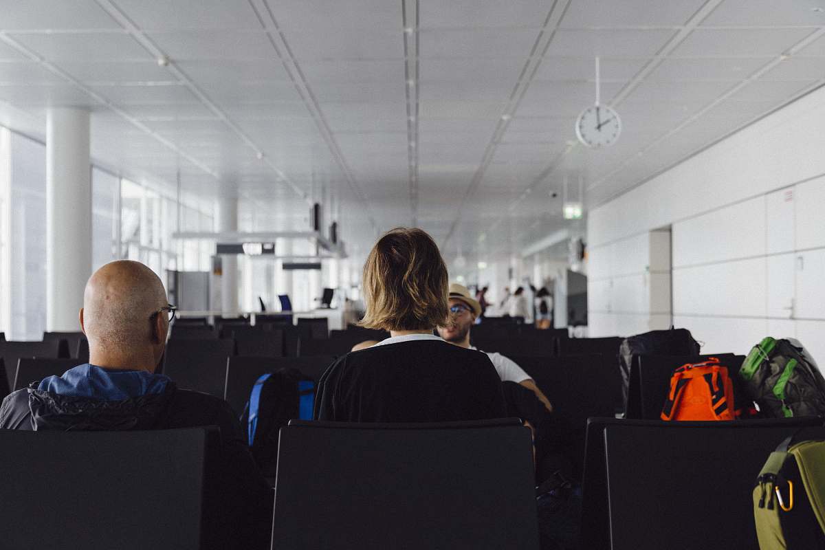 human people sitting on airport luggage