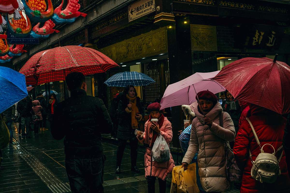 umbrella people standing on pathway holding umbrella canopy