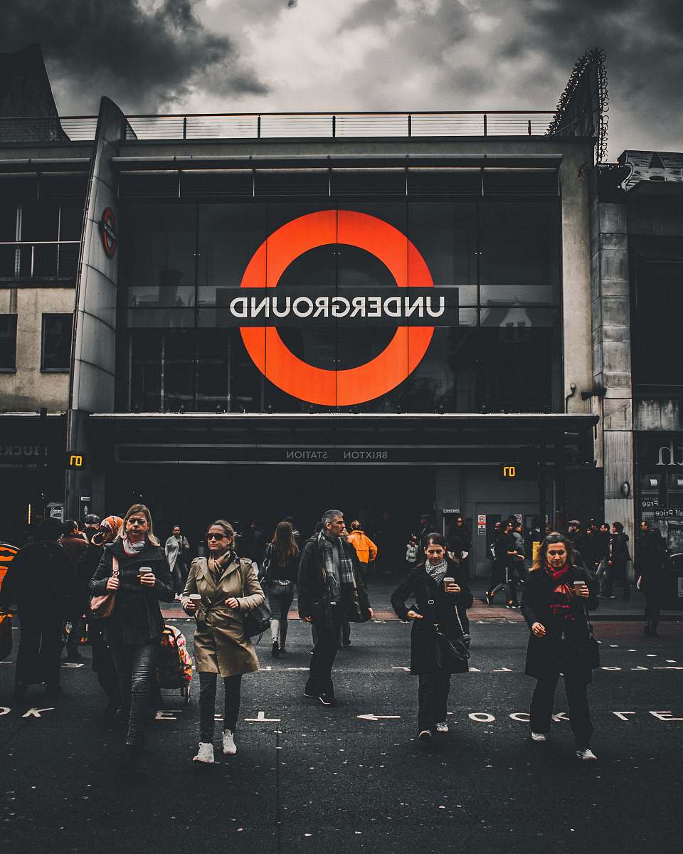 person people walking in front of Underground labeled building london