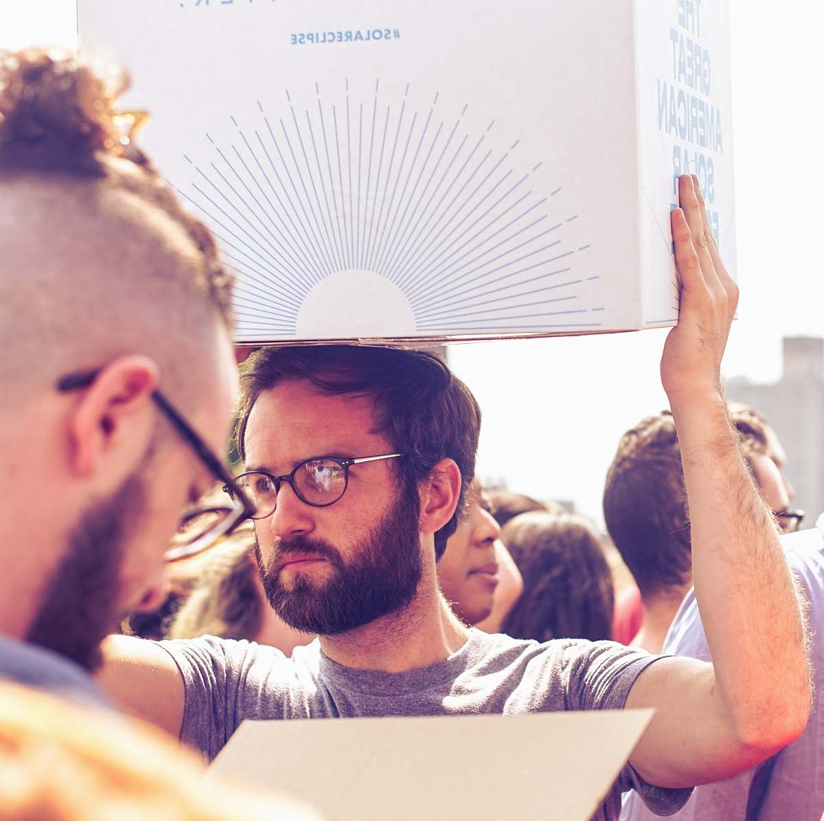 human person carrying white and blue box person