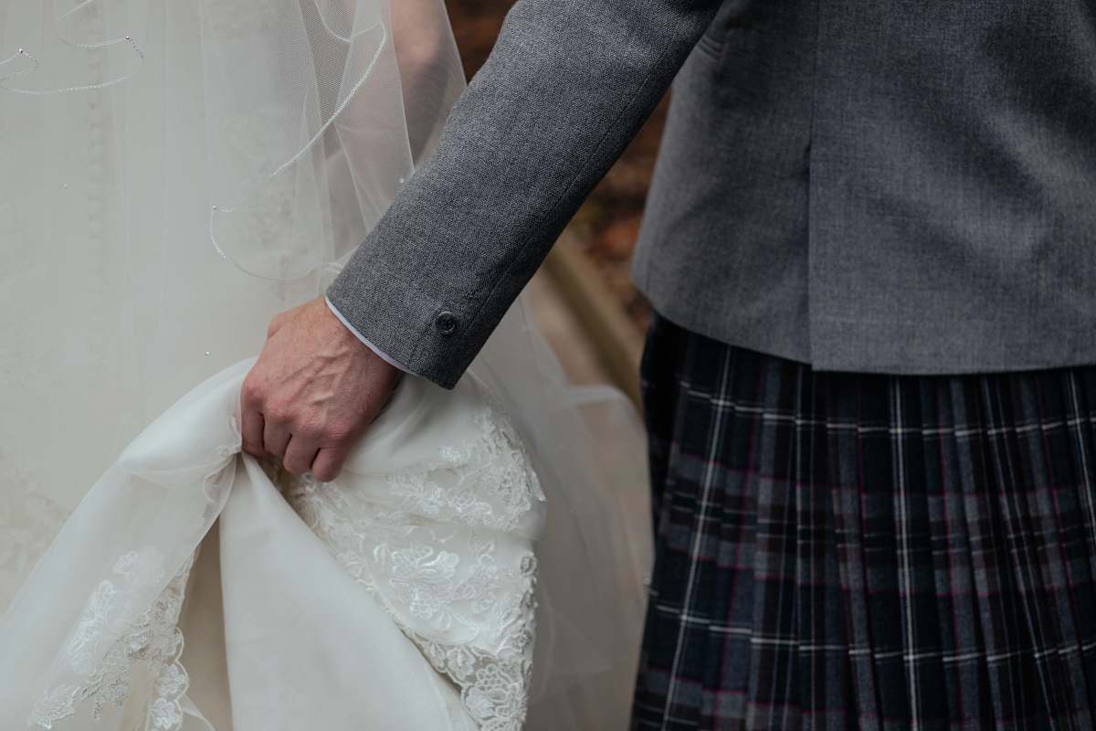 human person holding white wedding gown person