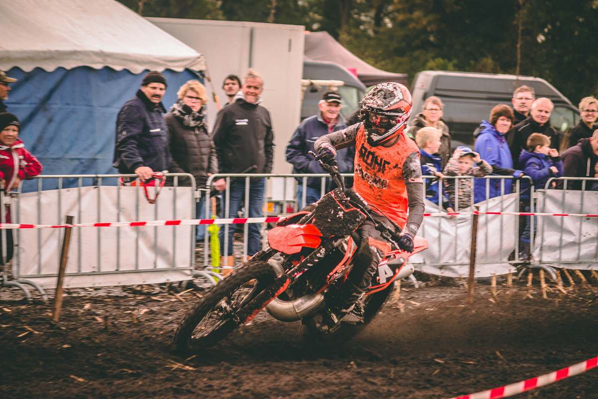 human person riding motocross dirt bike person