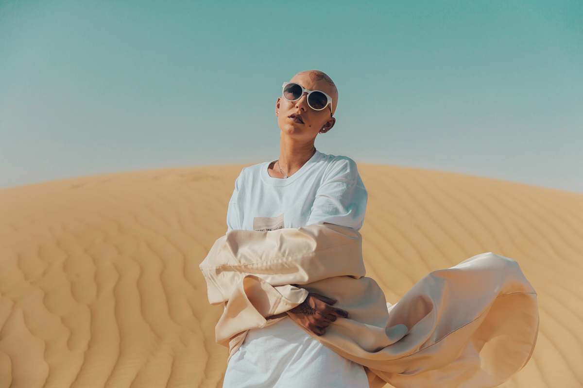 desert person standing on desert during daytime human