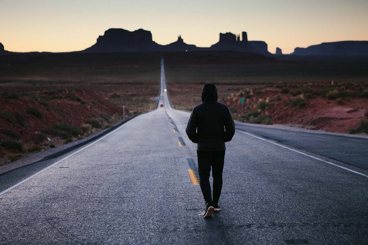 human person walking in the center of the road person