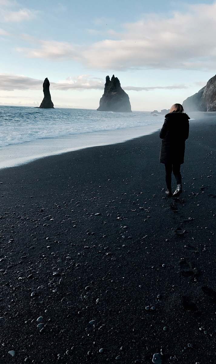 person person walking near body of water iceland