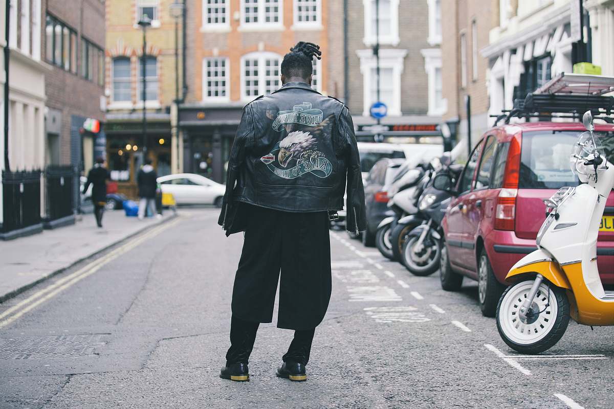 human person wearing black jacket on road person
