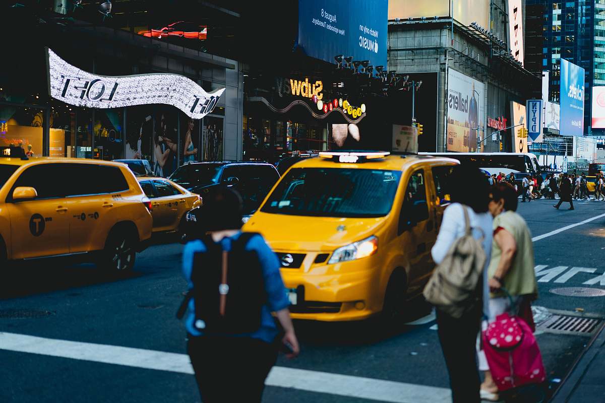 cab persons standing on pedestrian lane taxi