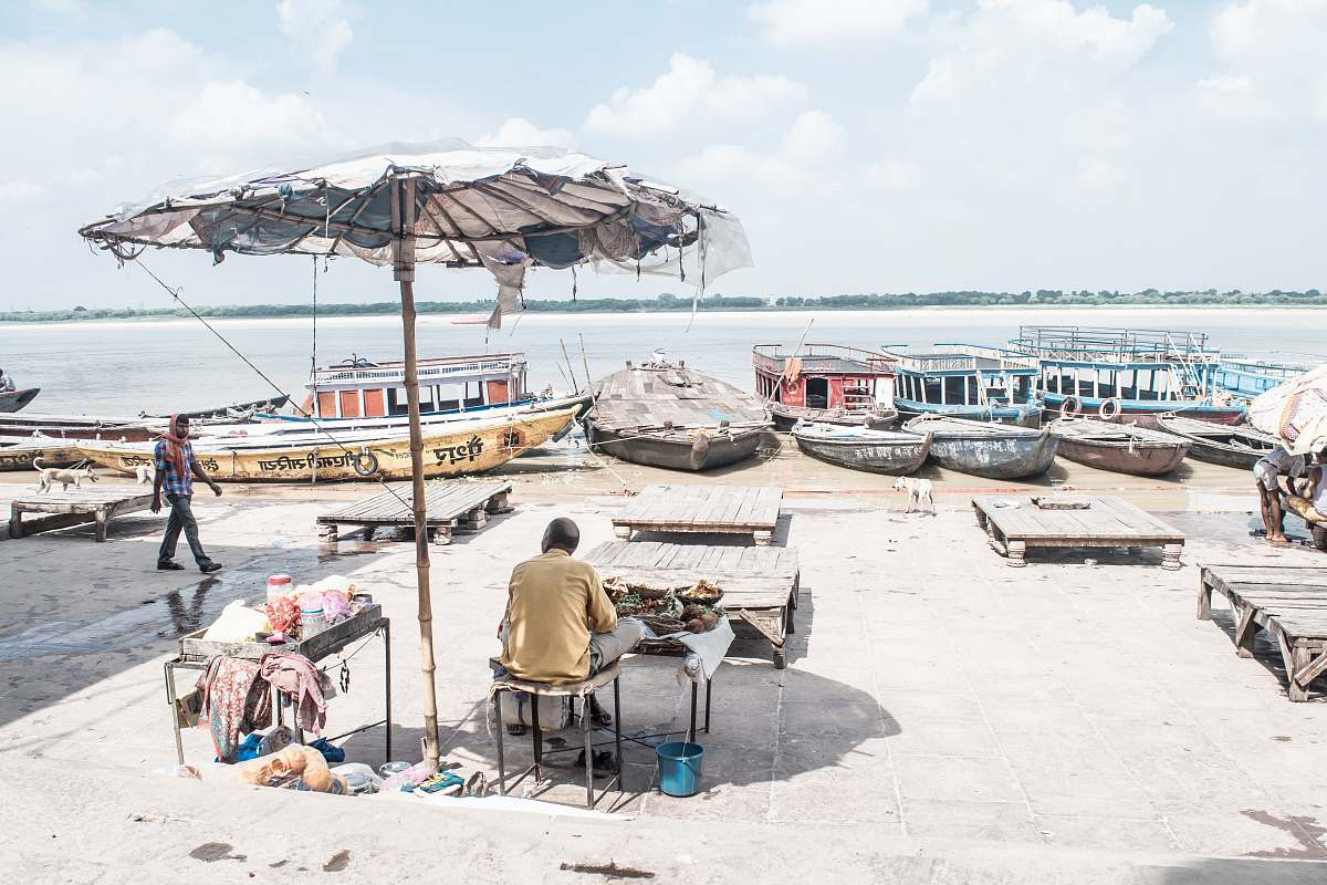 person photo of man under patio umbrella near body of water human