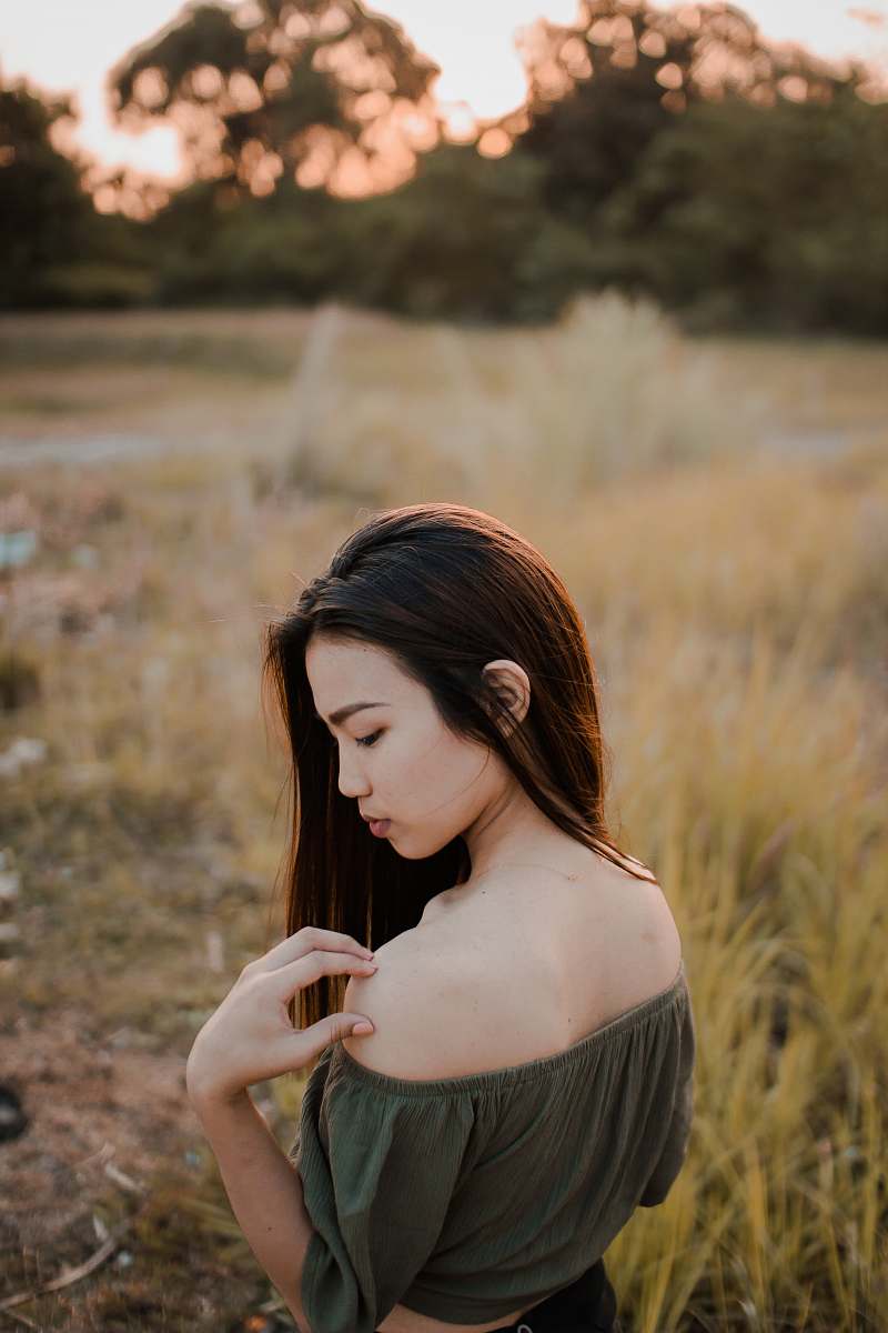 person photo of woman wearing off-shoulder top in greenfield human
