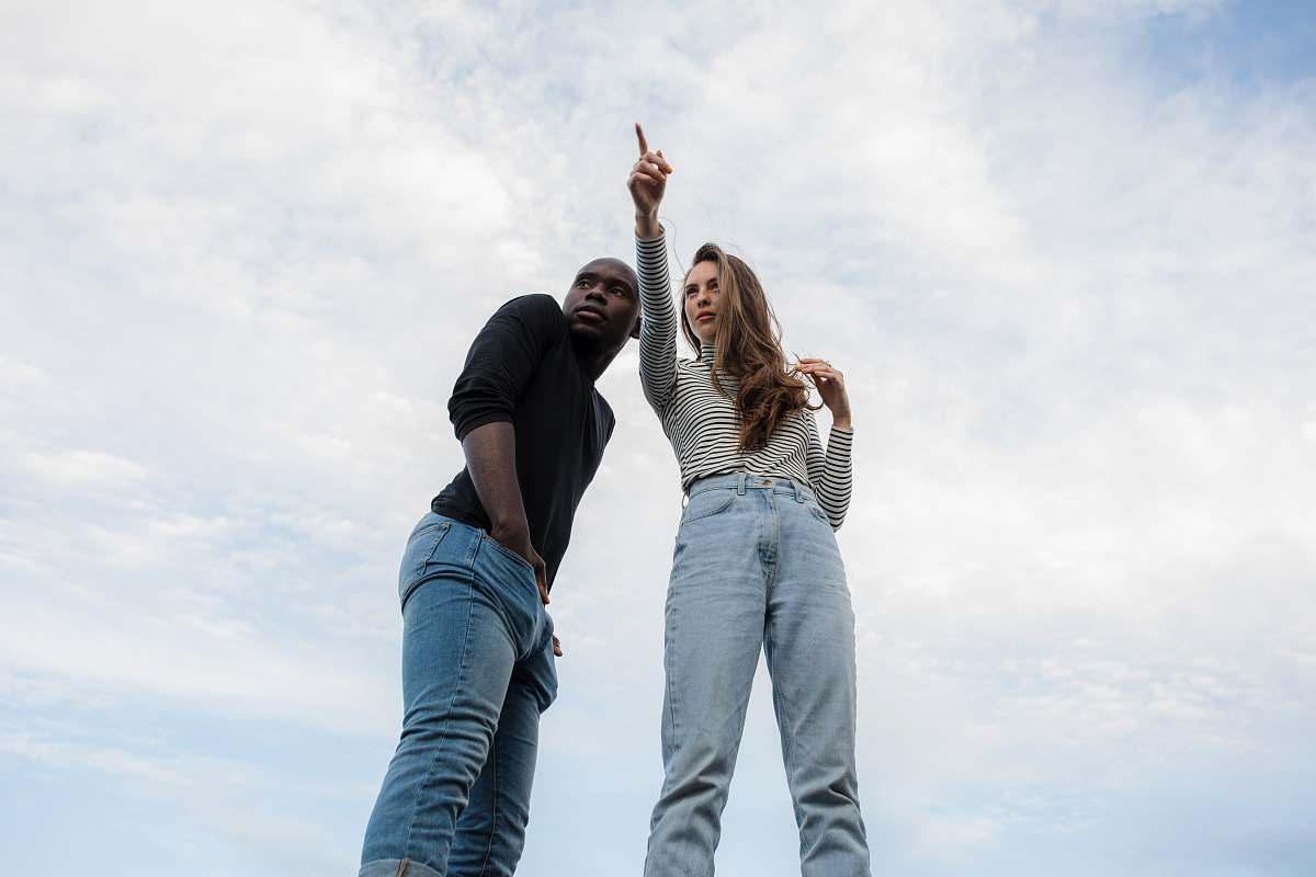 human photography of woman pointing her finger near an man person