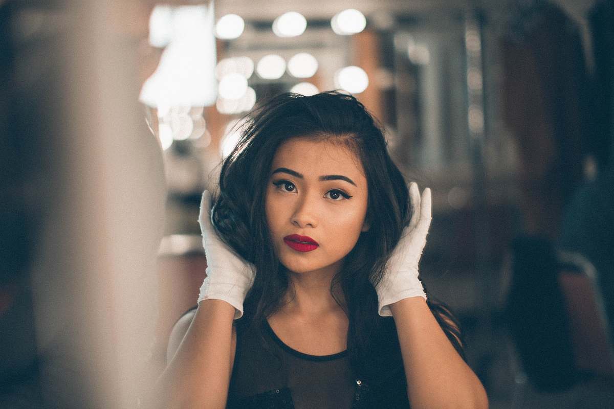 human selective focus photography of woman holding her hair woman