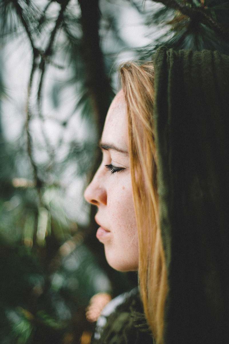 human selective focus photography of woman with green hood person