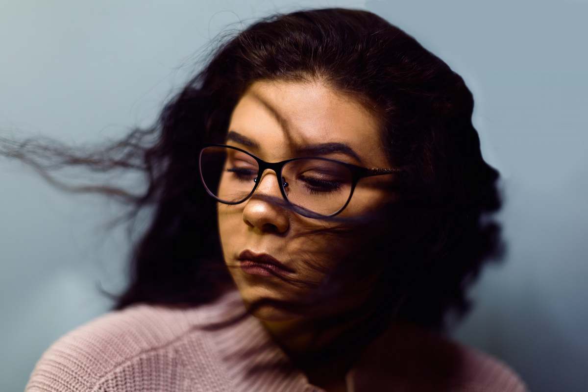 person selective photography of woman wearing gray knit top and black framed eyeglasses glasses