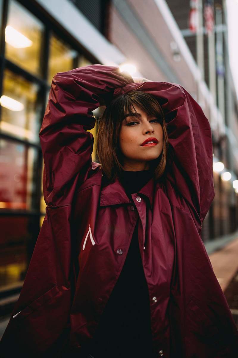human shallow focus photo of woman raising hands person