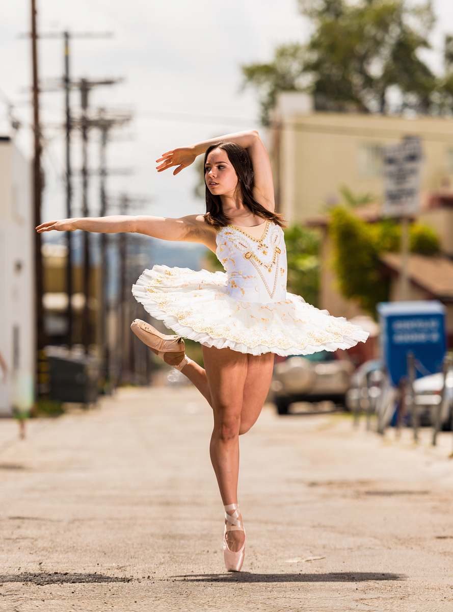 person shallow focus photography of woman in white dress dancing dance