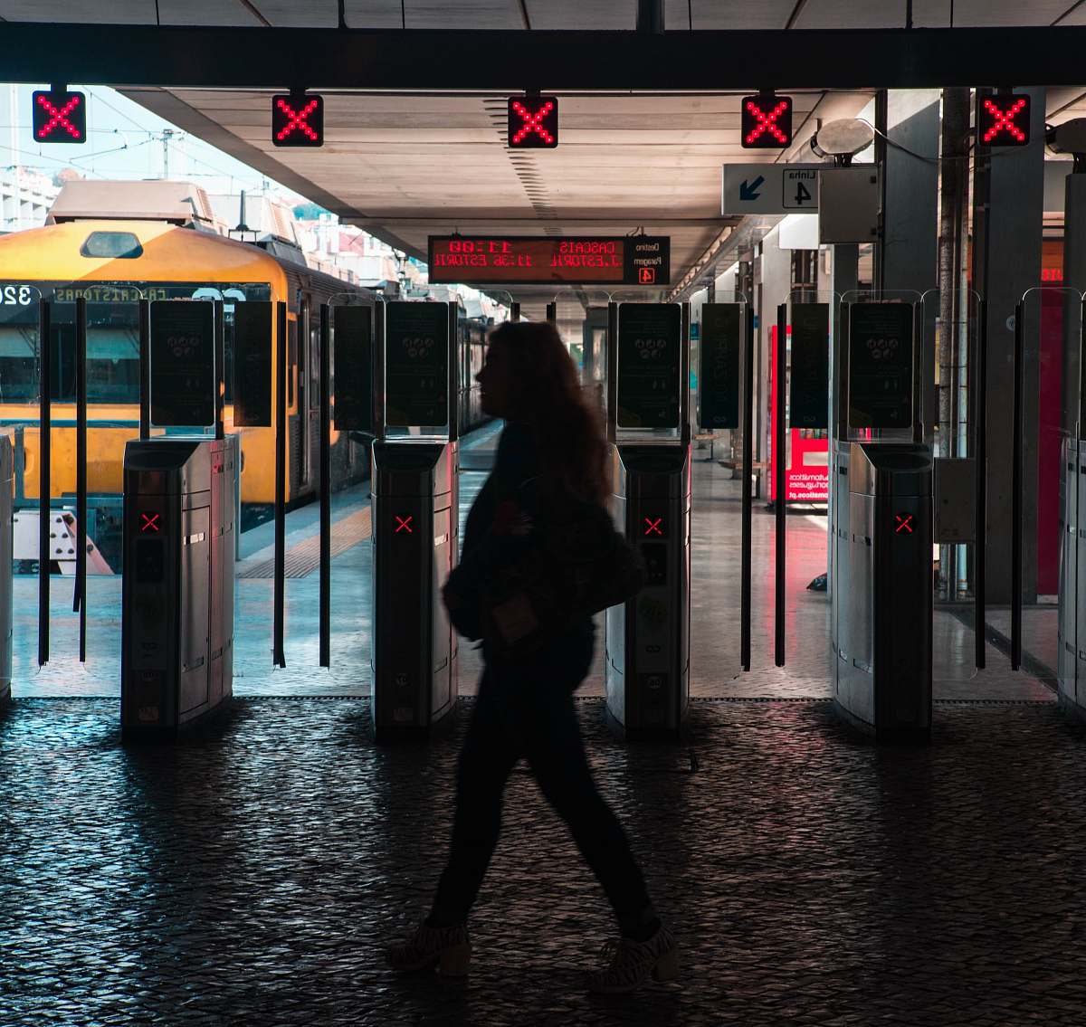 human silhouette of woman walking on train station train