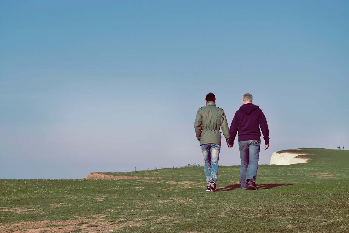 person two person walking on green grass field human