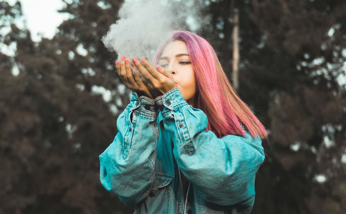 person woman blowing powder off her hands human