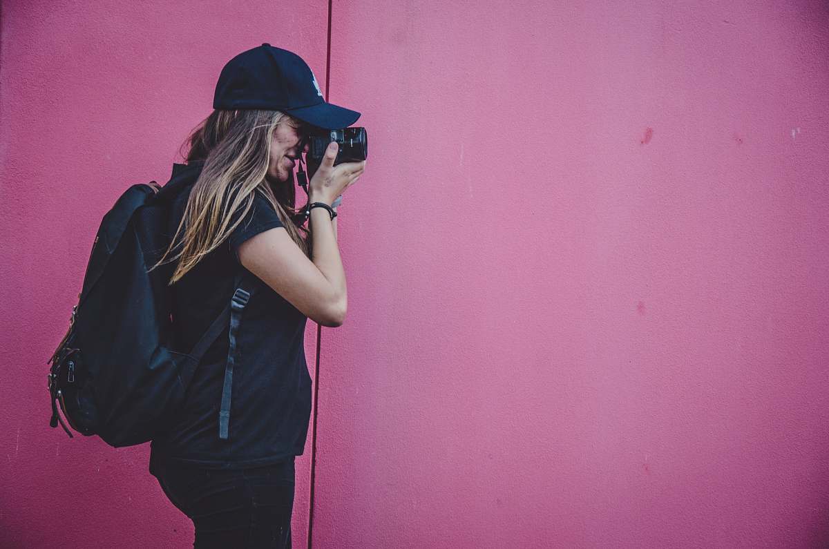 human woman holding camera taking photo person