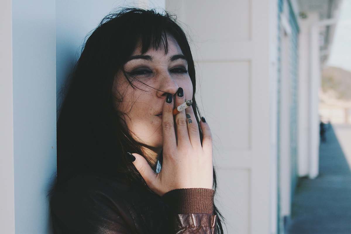 human woman holding cigarette stick person