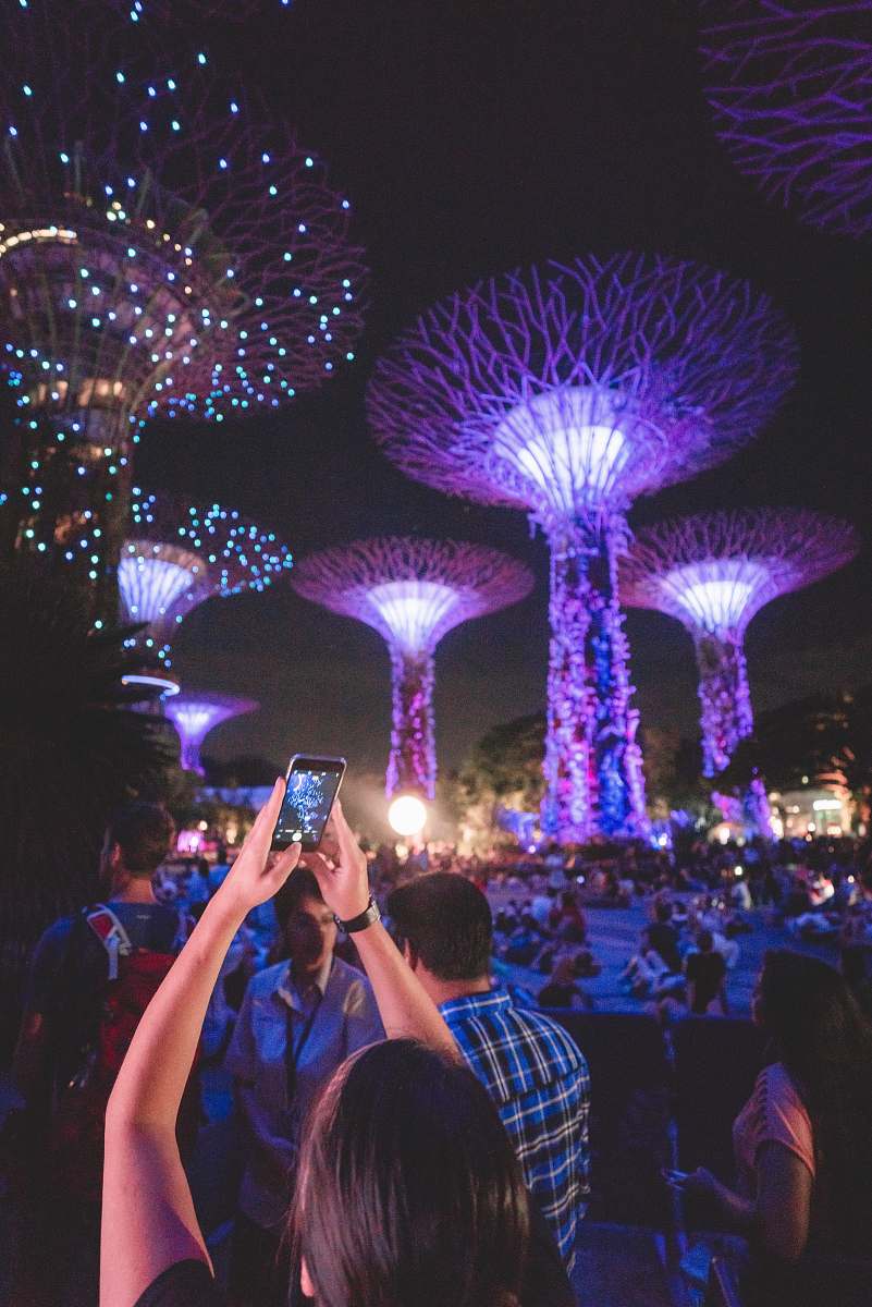 person woman holding smartphone up while taking picture human