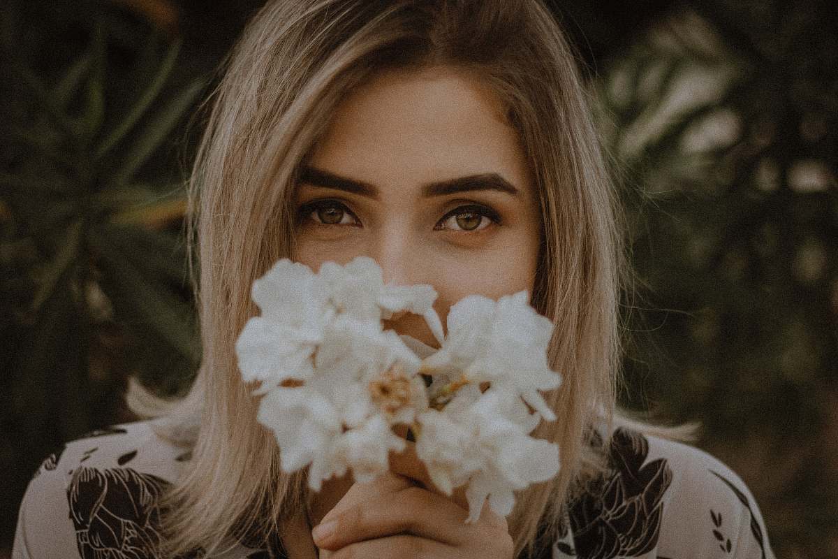person woman holding white petaled flower human