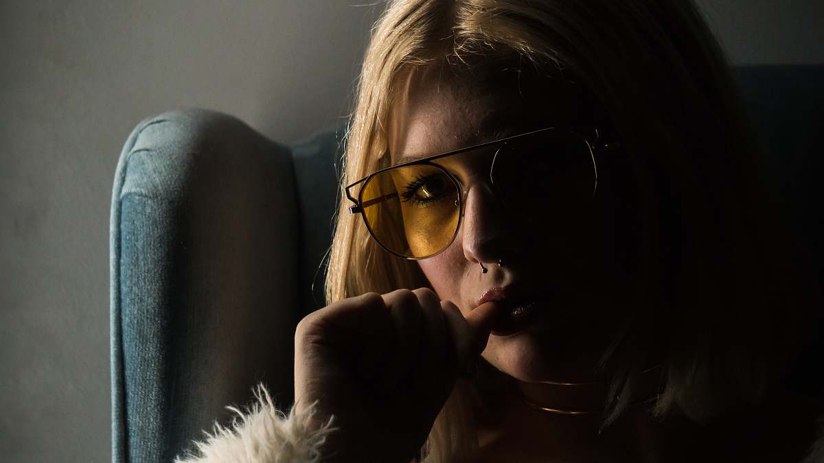 human woman in black frame yellow lens sunglasses person