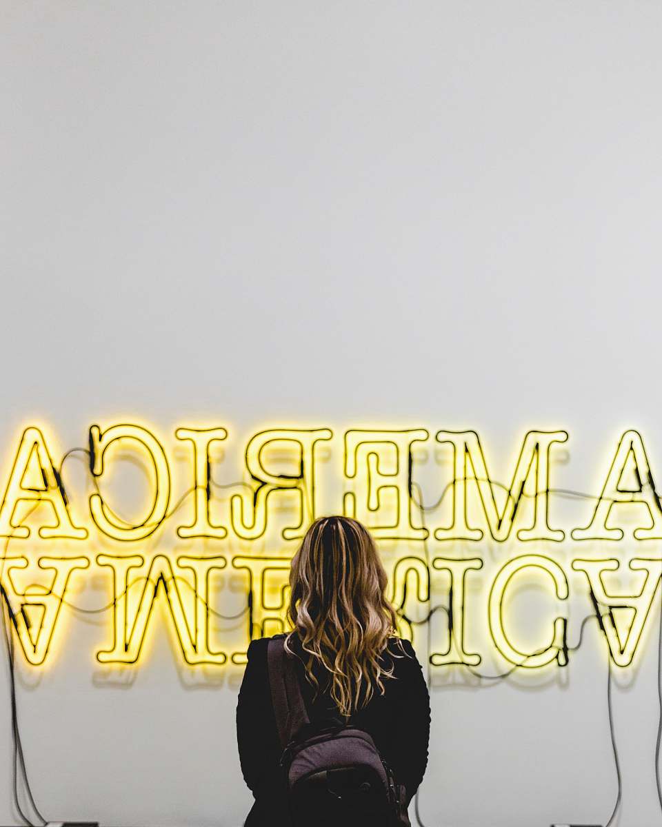 person woman in front American lighted signage human