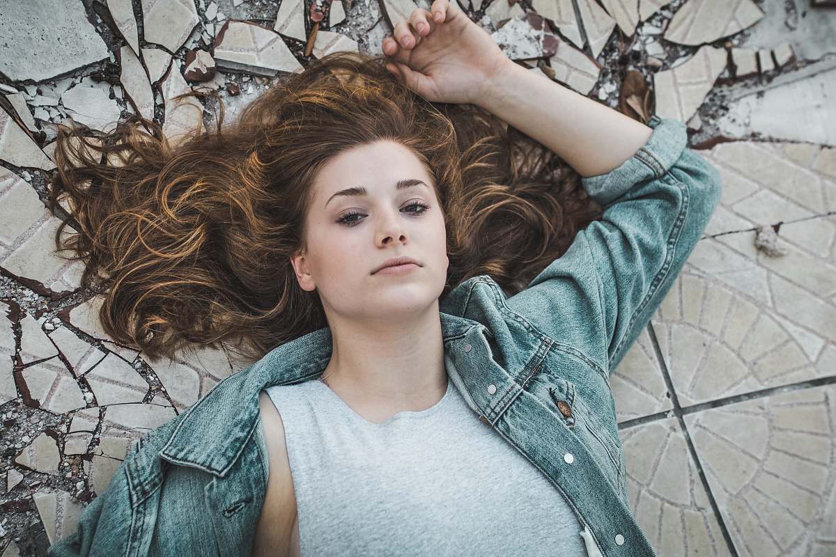 person woman laying on crack tiles human